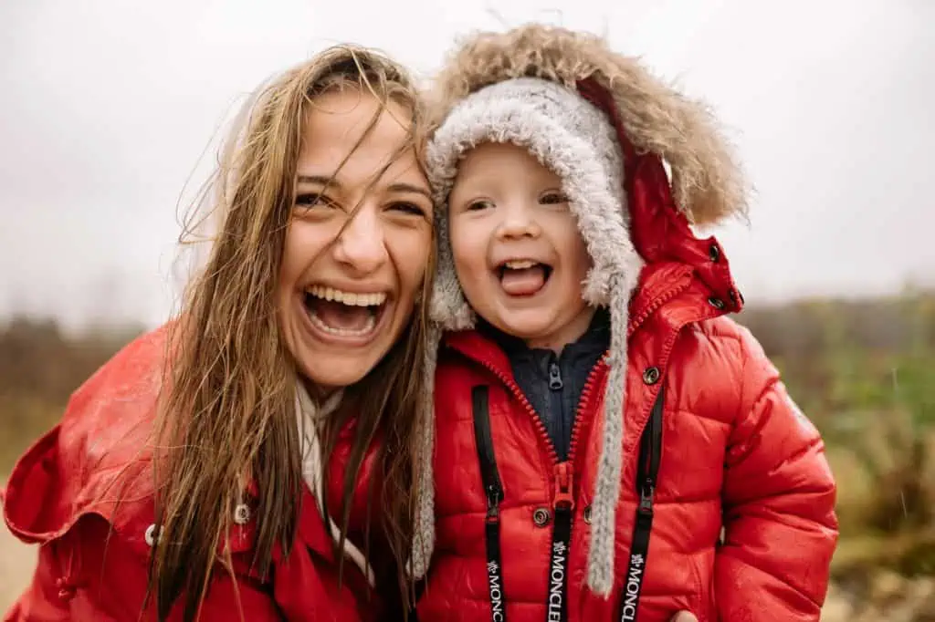 a woman laughing with her child