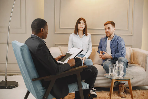 Married couple communicating at therapy office.