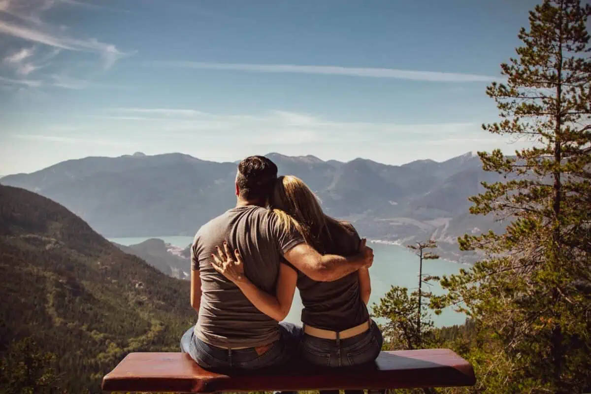 man and woman sitting on bench