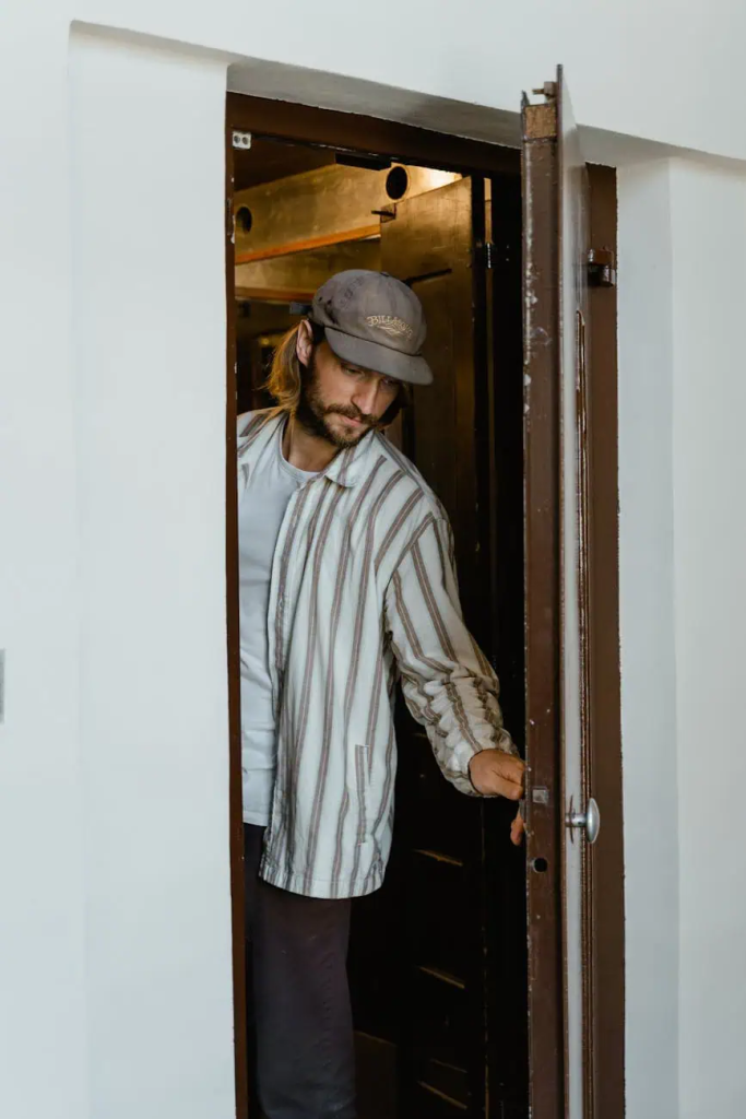 man closing the door