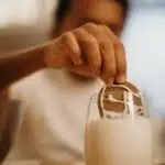 reward behavior change. selective focus photography of kid dunking cookie on milk