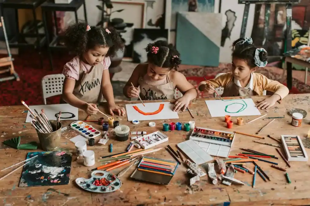 girls painting on a paper