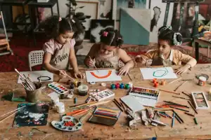 girls painting on a paper