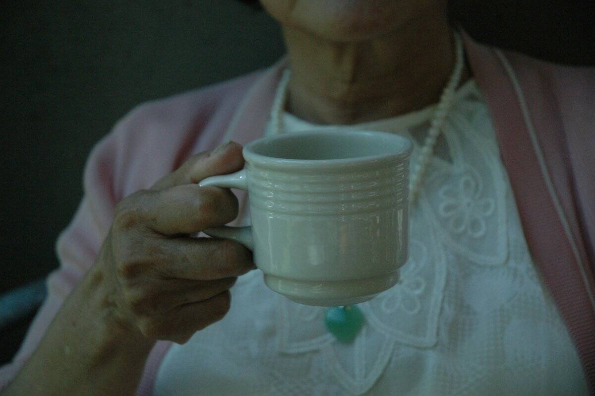 A serene moment of a parent enjoying a quiet cup of tea