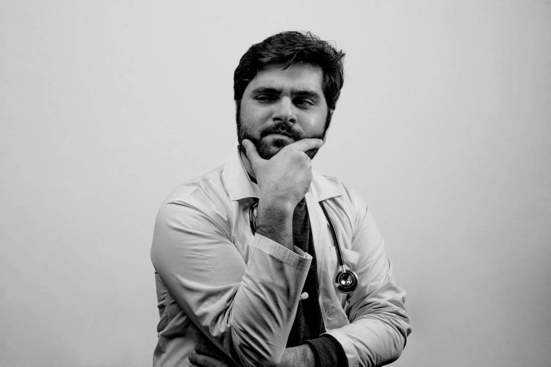 A doctor looking side ward thinking something - Black and White