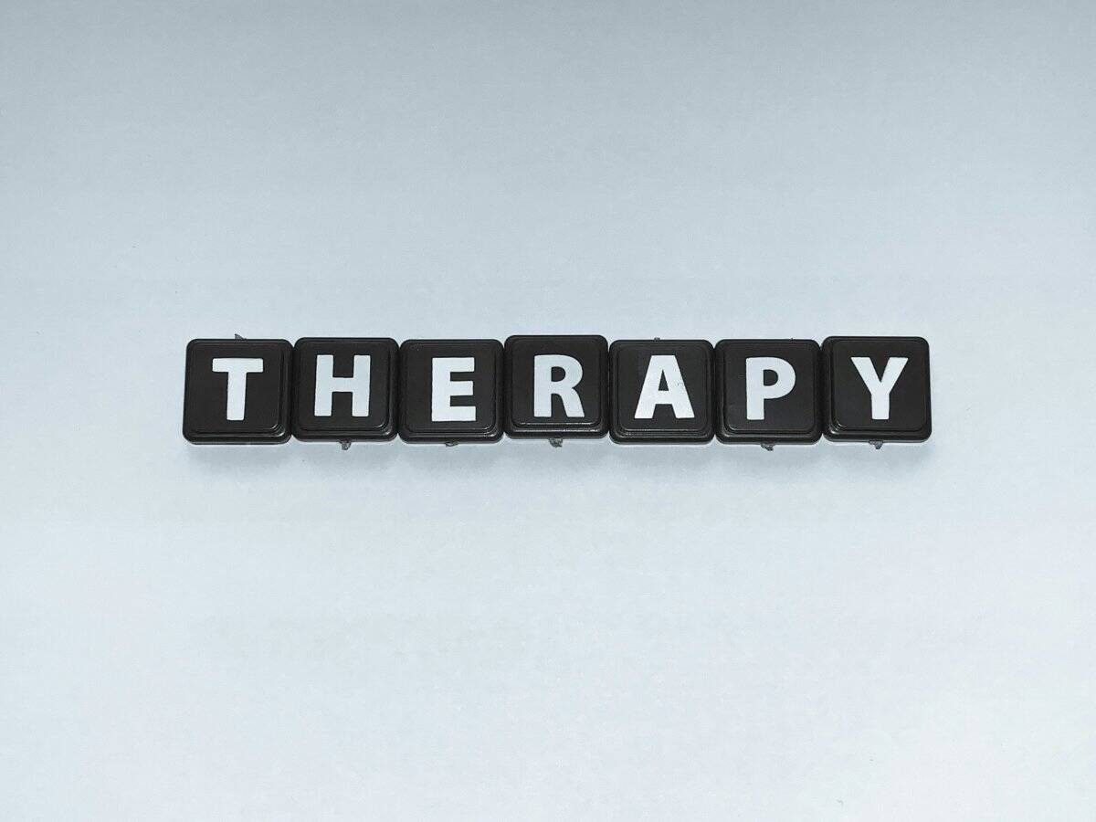 A therapist and a male client discussing mental health treatment options