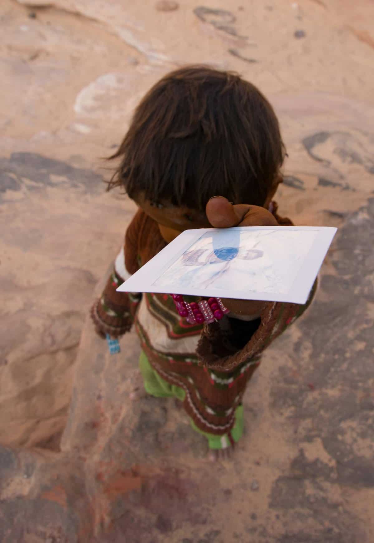 A parent guiding a child on a tablet, emphasizing educational engagement