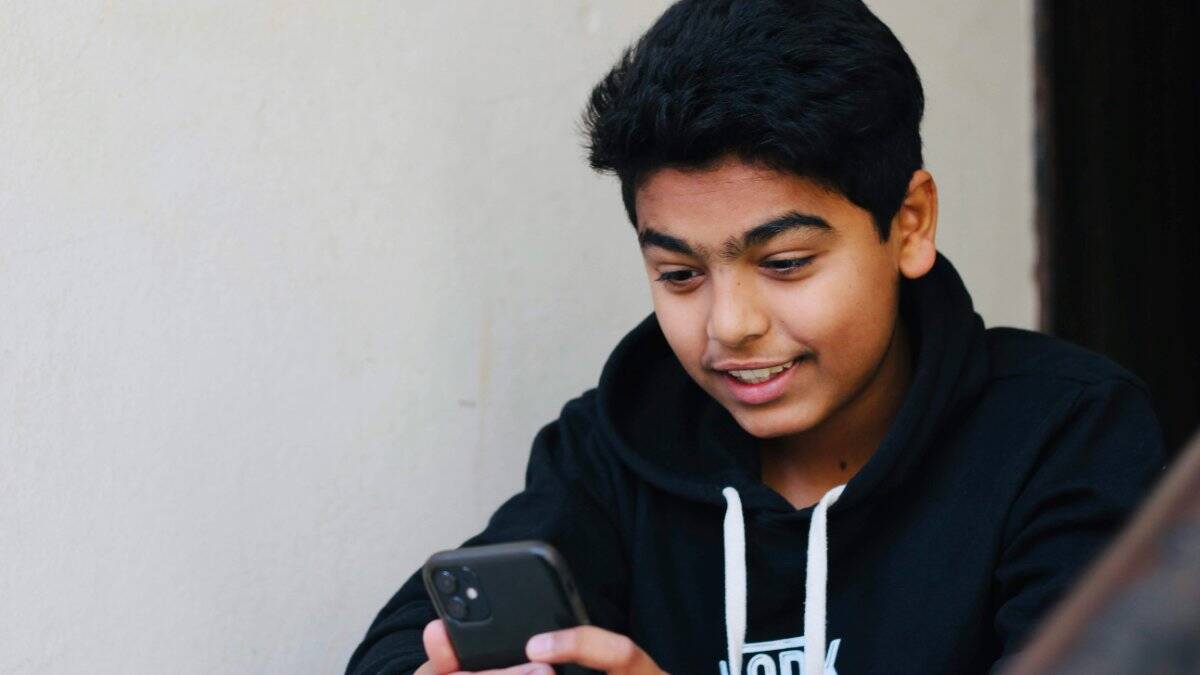 Teens engaging with technology collaboratively, illustrating balanced digital use