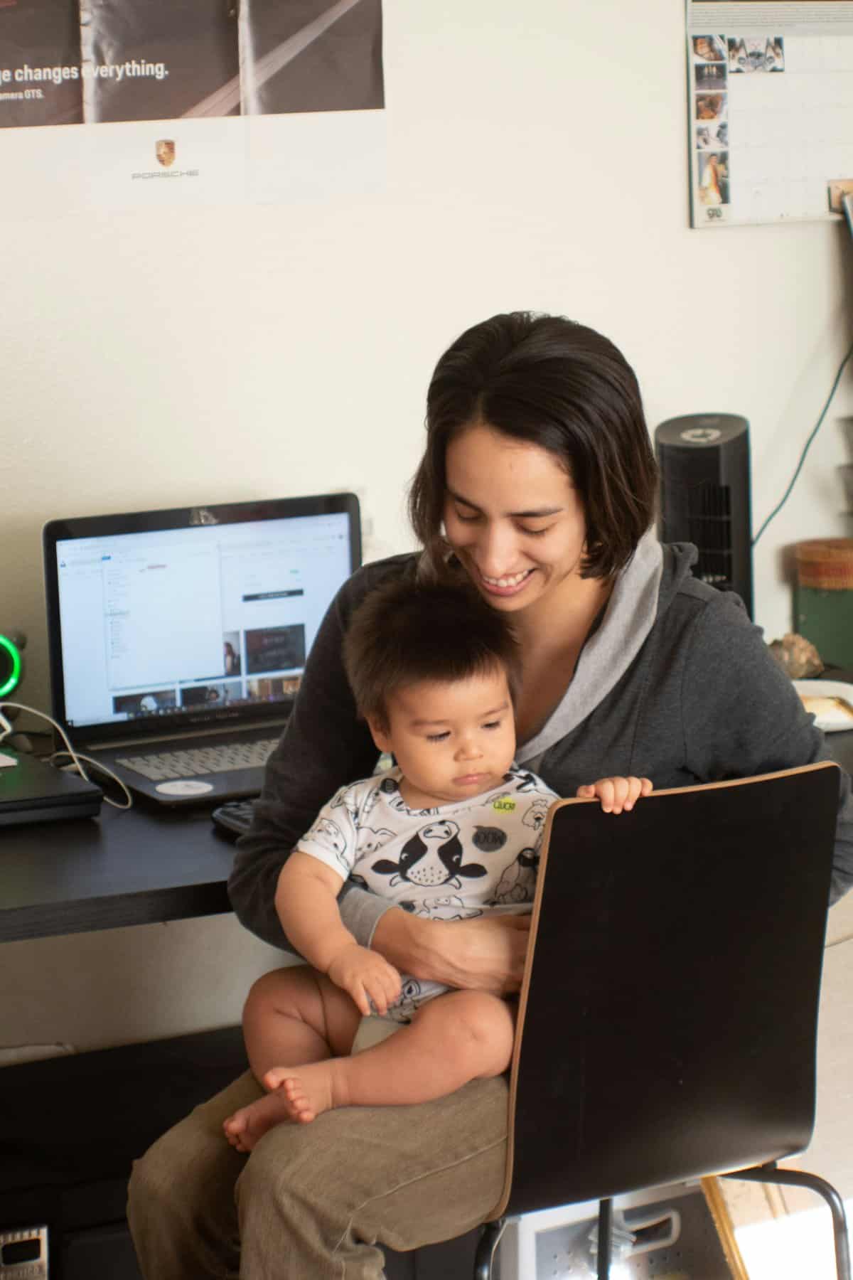 A parent and child looking at a tablet together, discussing online safety