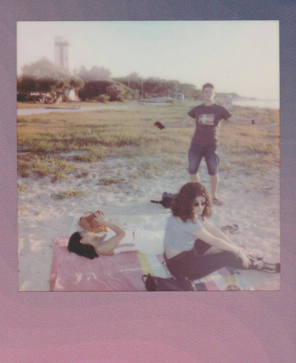 A family enjoying a picnic by the beach, laughing and having fun together.