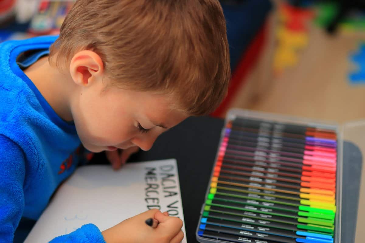 An illustration of a child surrounded by vivid colors and swirling lines indicating sensory overload