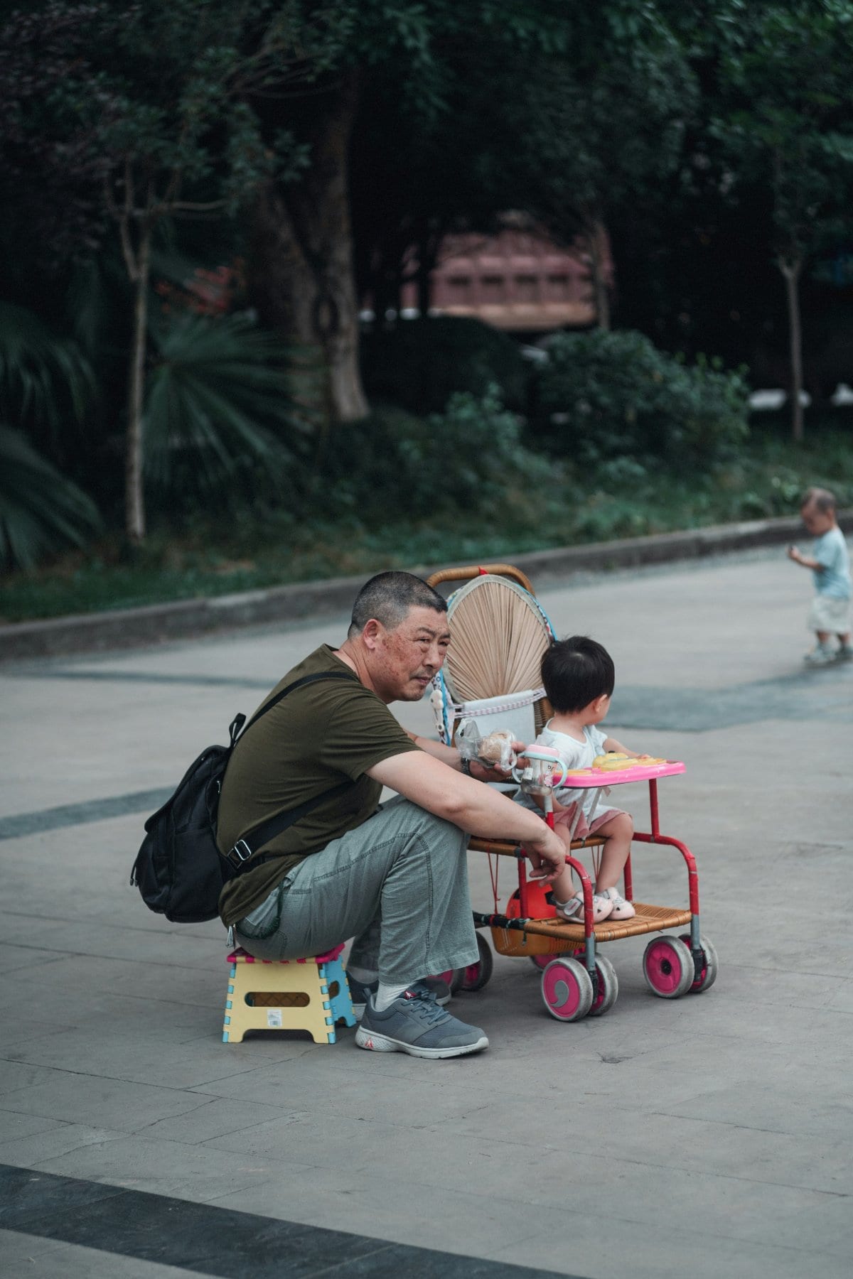 A father juggling work and family duties, looking thoughtful