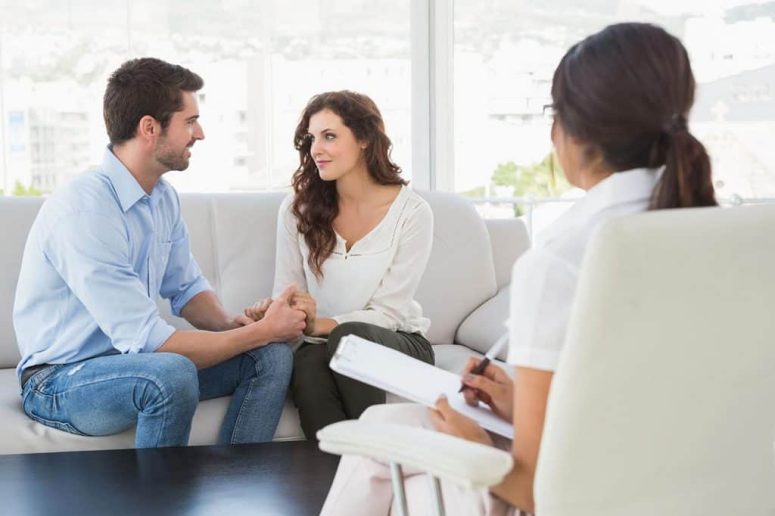 A calm, professional image of a couple engaged in conversation during a couples counseling session at a Davenport Psychology office in Sarasota or Venice, FL.